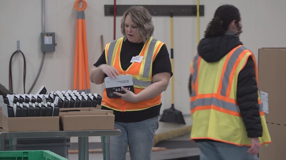 Volunteers inspect food items.