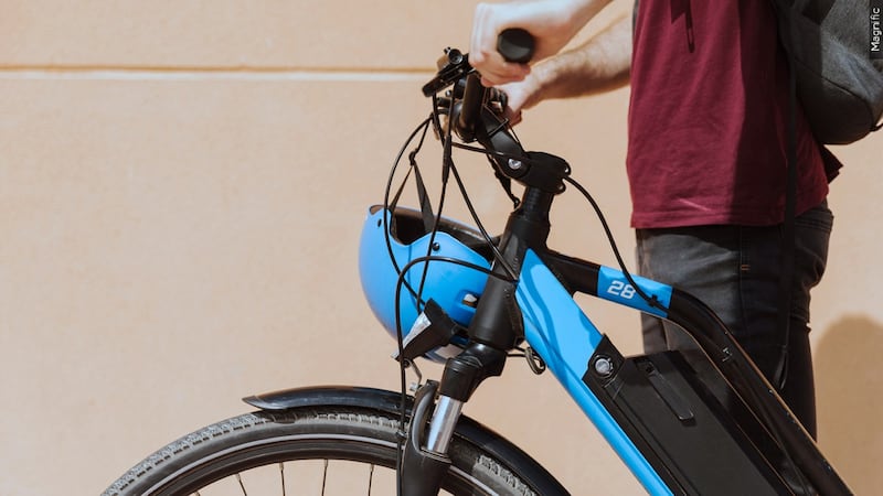 File photo of a child standing next to an e-bike.