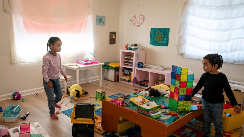 Neveah, left, 6, and brother, Choncey, 4, play at home in Oakland, Calif., on Friday Nov. 24,...